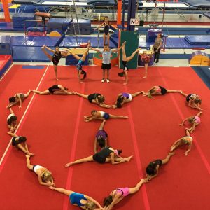 gymnasts forming a shape of a heart