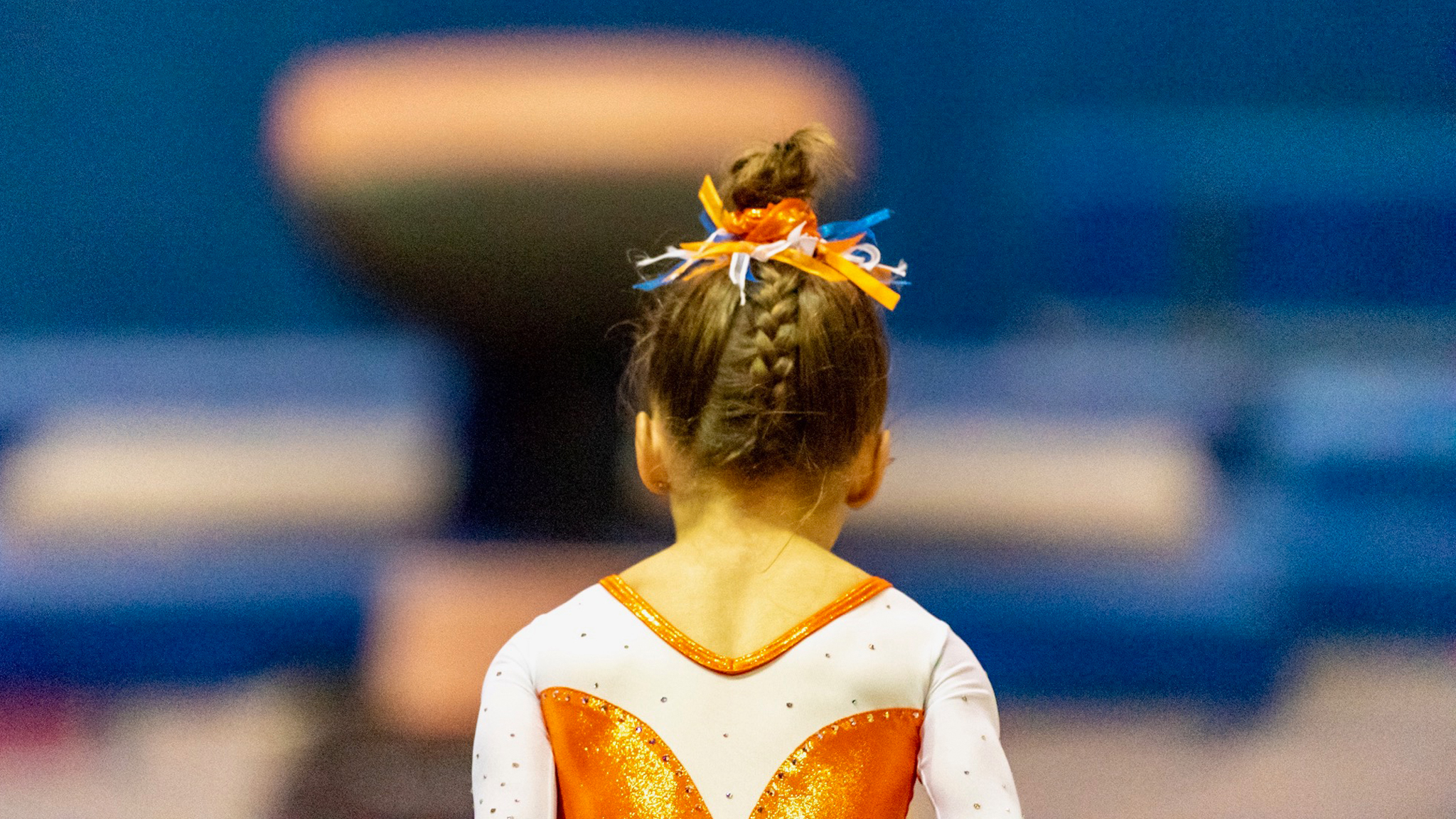 back of girl gymnast about to perform